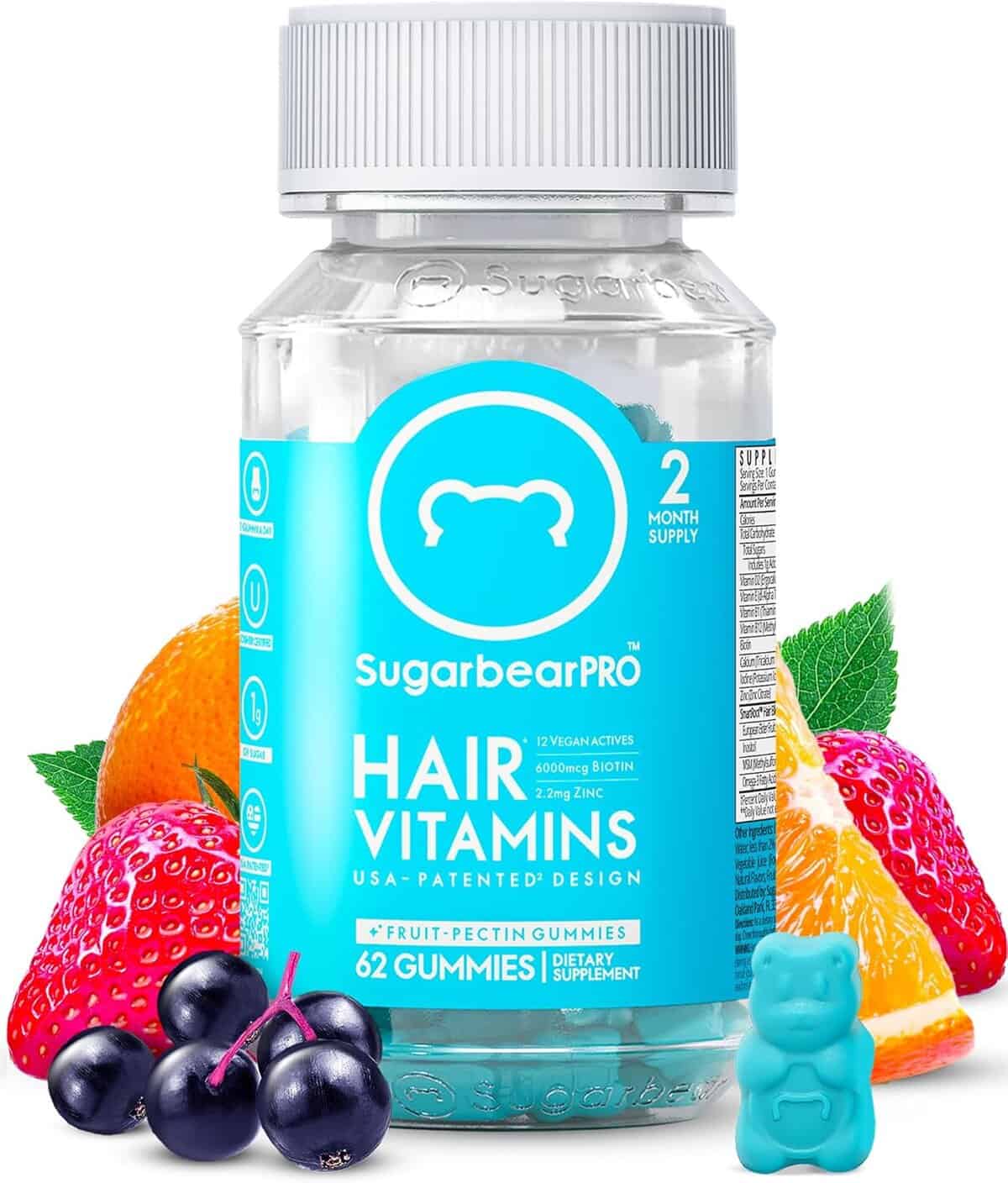 Clear bottle of SugarbearPro Hair Vitamins with a bright blue label, surrounded by colorful fruit like oranges, strawberries, blackberries, and a gummy bear in front, highlighting the fruit-pectin vegan gummy formula.