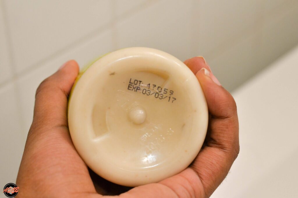 Bottom of a Shea Moisture bottle showing an expiration date labeled EXP: 03/03/17 printed in black ink.