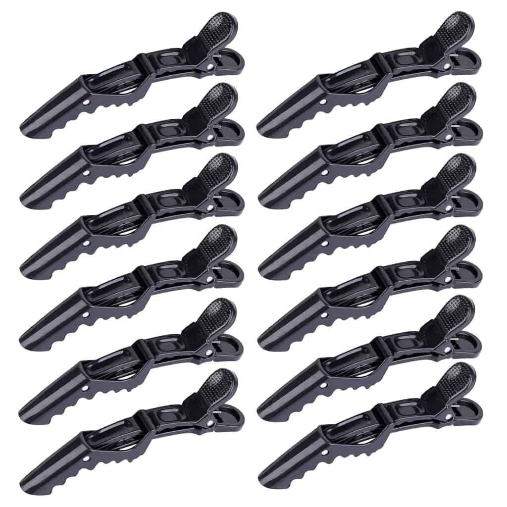 Set of black alligator hair clips arranged in rows, ideal for sectioning hair during styling