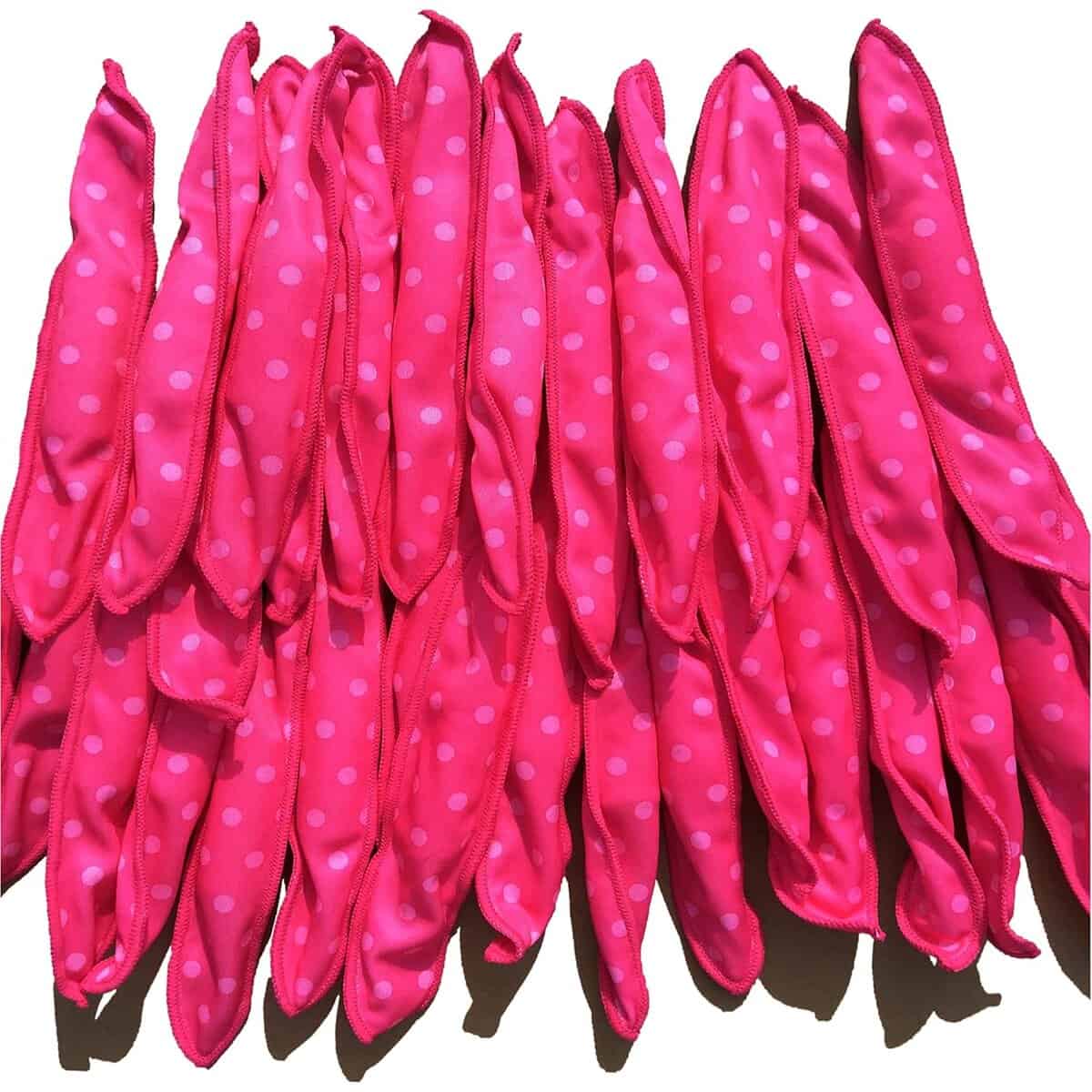 Bundle of bright pink satin pillow hair rollers, ideal for creating overnight heatless curls