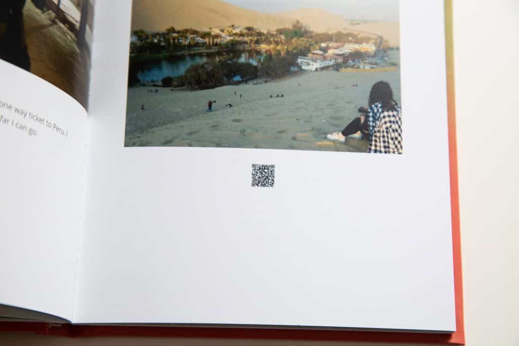 Printed Kinnect memory book page with a scenic photo and a scannable QR code linking to digital memories.