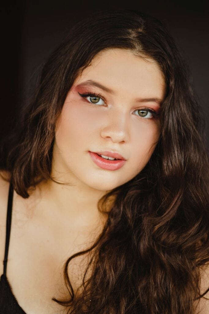 Woman with natural 2B waves and soft brown hair texture close-up.