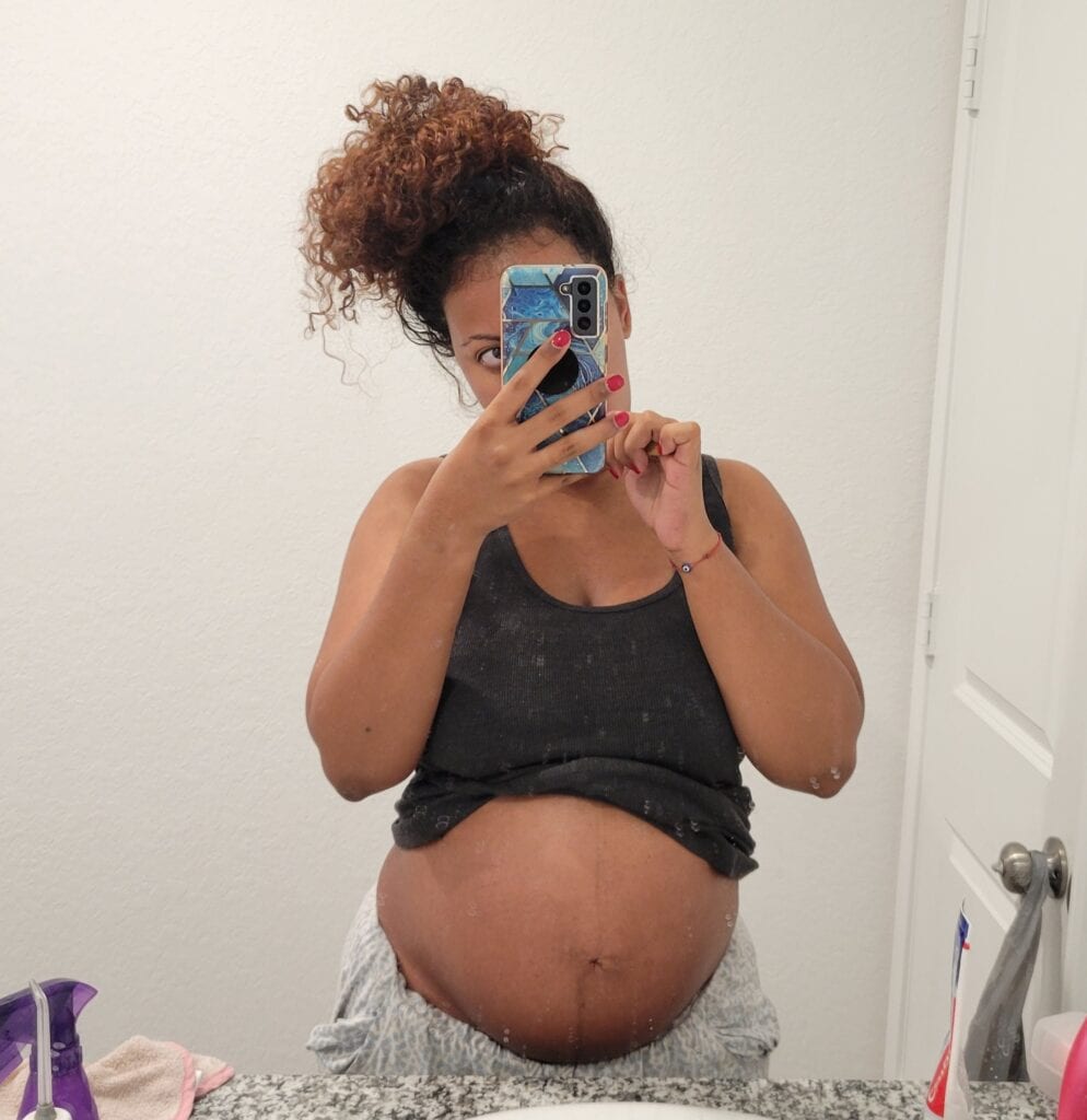 21 weeks pregnant belly with smooth skin and no visible stretch marks.