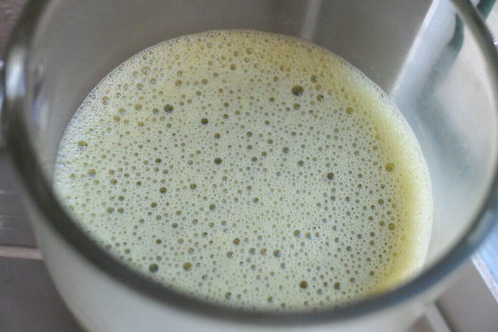 Close-up view of a homemade Jade Leaf matcha latte showing the creamy frothy top made using an Instant Pot milk frother.