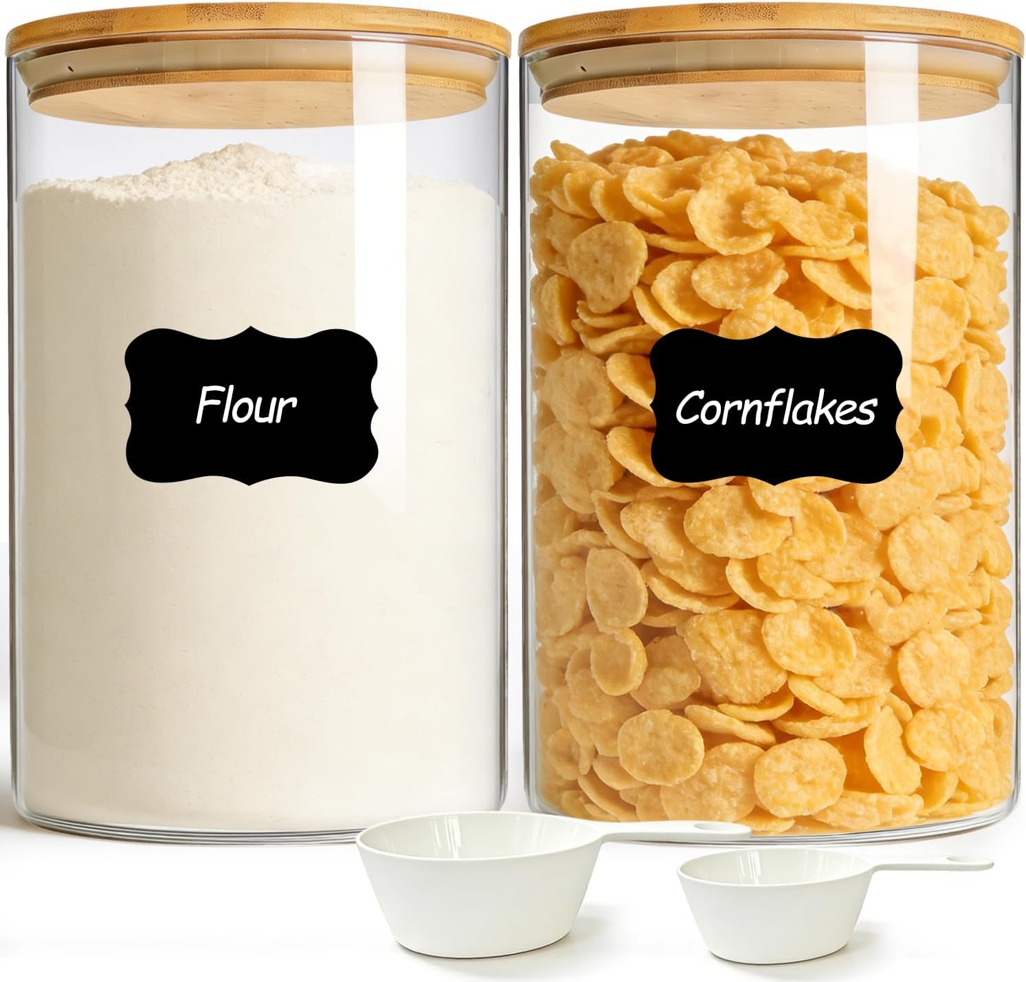 Large glass airtight storage containers with bamboo lids for flour, cereal, and pantry ingredients.